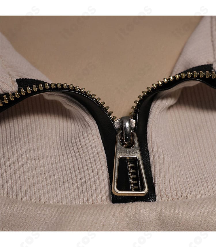 衣装のファスナー装飾ディテール。引き手の形状と縫製ステッチ、開閉位置の仕立てを拡大表示。